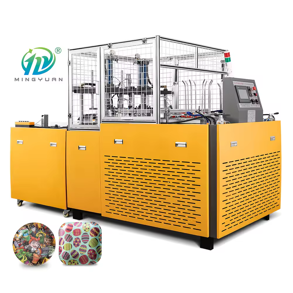 Operator working with automatic Dona plate machine in a paper plate manufacturing unit.